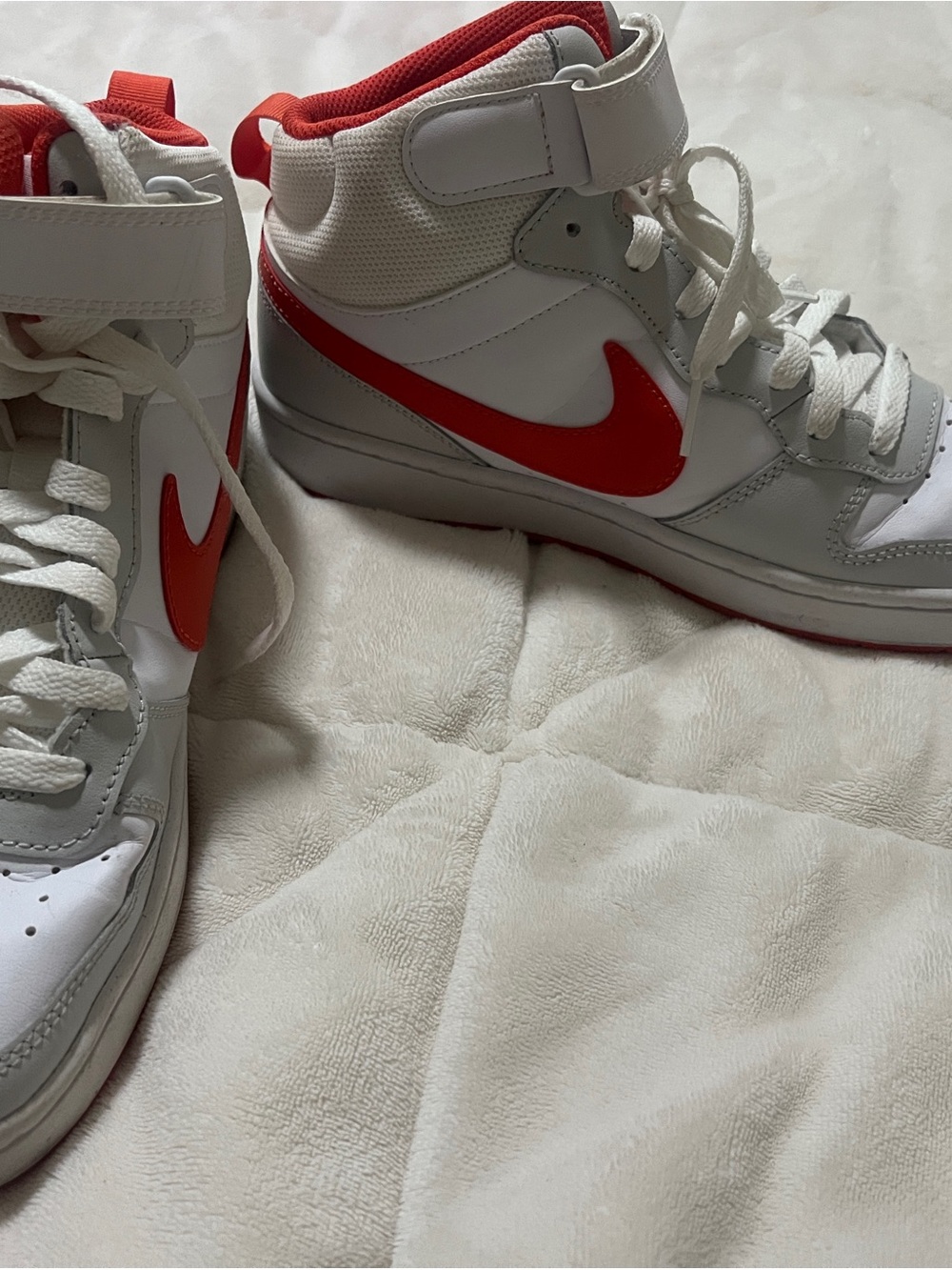 Nike Kids' High-Top Sneakers in White with Orange Swoosh